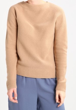 Maglione beige lavorato a maglia con scollo rotondo e polsini a costine, caratterizzato da un motivo testurizzato e orlo dritto. Materiale morbido.