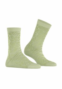 Chaussettes vert clair avec un motif texturé, un bord côtelé et une coupe ajustée, fabriquées à partir d'un matériau doux et extensible.