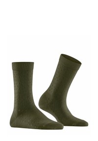 Chaussettes en coton vert olive avec des bords côtelés, ornées de petites dot textures sur toute leur surface. Longueur mi-mollet, design doux et ajusté.