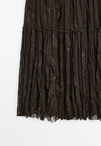 Dark brown, tiered skirt made of lightweight fabric with crinkled texture. Features subtle floral patterns in a slightly lighter shade.
