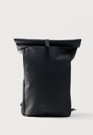 Black roll-top backpack with smooth matte finish and single strap closure, standing upright on a plain light background.