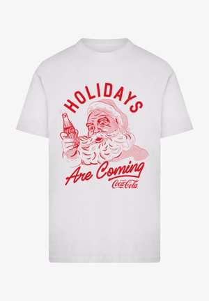 White cotton t-shirt featuring a red graphic of Santa holding a Coca-Cola bottle, with the text "HOLIDAYS Are Coming" above.