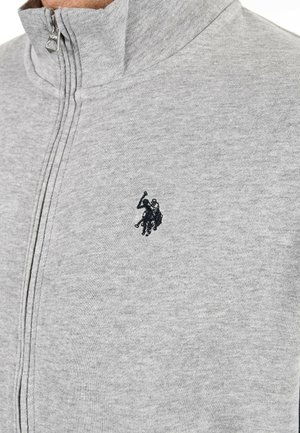 Gray zip-up sweatshirt made of soft fabric, featuring a high collar and a small, dark embroidered logo of a horse and rider on the chest.