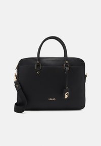 Musta nahkainen käsilaukku, jossa on kaksinkertaiset kahvat, kultaiset metalliyksityiskohdat, irrotettava olkahihna ja logotunniste. Sileä pinta, jämäkkä muotoilu.