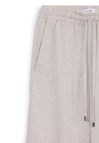 Helle beigen Leinenhosen mit elastischem Bund, Seitentasche und Kordelzug mit Metallspitzen, Etikett "CALLIOPE" innen sichtbar.