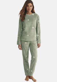 Ensemble de pyjama en polaire verte avec un motif texturé matelassé orné d'étoiles. Le haut a des manches longues et le pantalon a une coupe slim.