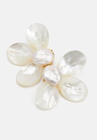 Broche de flor de perlas blancas con seis pétalos en forma de pieza, de superficie suave e iridiscente, y un centro de metal en tono dorado para la sujeción.