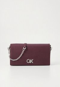 Borsa crossbody in pelle color marrone rossiccio con tracolla a catena argentata, dotata di chiusura a patta magnetica e un prominente logo argentato sul davanti.