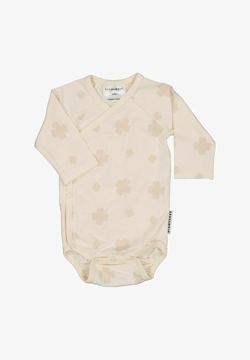 Lys beige langærmet bodysuit med indpakningsdesign, der har et subtilt blomstermønster og trykknapper i bunden for nem påklædning.