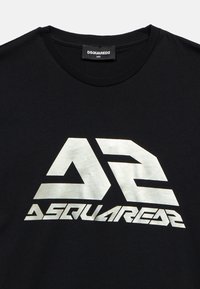 Camiseta negra de cuello redondo con logo grande estilizado "DS" en blanco y texto "DSQUARED2" impreso en el pecho, etiqueta muestra talla 14Y.