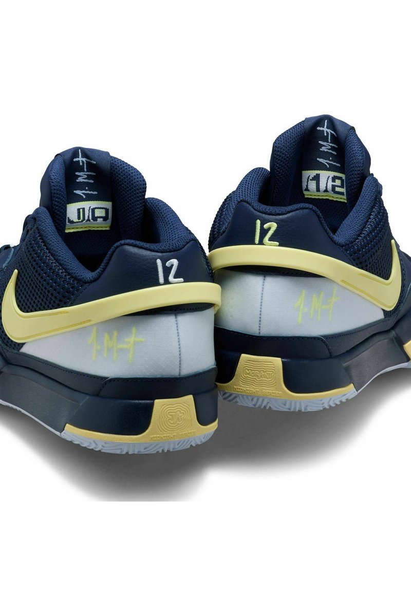 Niebieskie i szare sportowe sneakersy z żółtymi akcentami. Charakteryzują się siateczkową cholewką, detalami w środkowej części podeszwy oraz unikalnymi oznaczeniami na piętach.