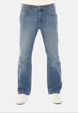 Light blue denim jeans with a straight-leg cut, five pockets, and subtle stitching details, paired with white sneakers.
