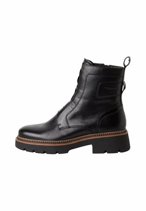Black leather ankle boot with a rounded toe, zip closure, and textured detailing. Features a chunky heel and contrasting brown sole.