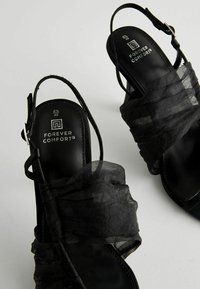 Next Pahkluukinnisega rihmikud - black