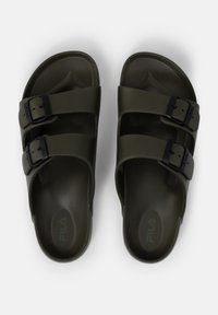 Dark green plastic sandals featuring two adjustable black buckles, a textured footbed, and a contoured shape for comfort. Fila logo visible.