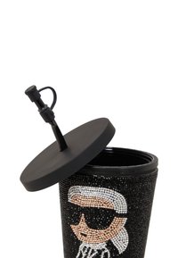 Conteneur noir avec un couvercle rond, orné de strass présentant un design de visage proéminent. Texture lisse, en plastique.