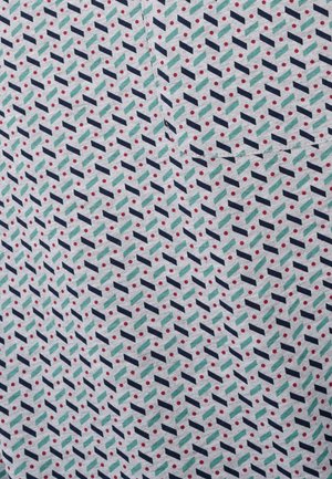 Patterned fabric featuring a geometric design with dark blue, green, and red accents on a light background with repeating shapes and dots.