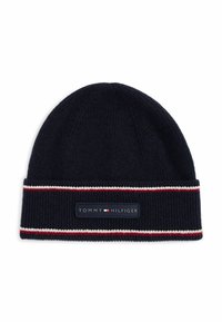 Granatowa dzianinowa czapka z prążkowanym wzorem, z podwiniętym mankietem i metką z napisem "TOMMY HILFIGER" oraz czerwonymi i białymi paskami.