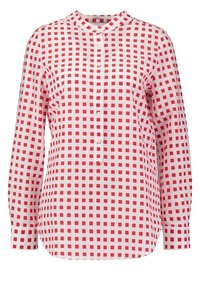 Valkoinen pitkähihainen paita, jossa on punainen ruutukuvio ja napitus edessä.