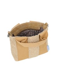 Pequeño bolso texturizado en tonos beige y marrón claro con dos asas, interior con cremallera y forro estampado visible en su interior.