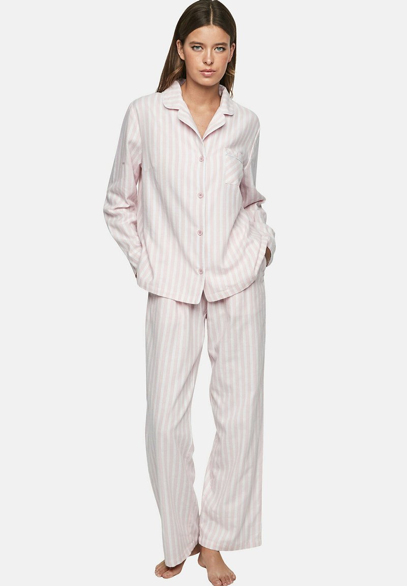 Ensemble de pyjama rayé rose et blanc en tissu doux, comprenant un haut à boutons avec une poche et un pantalon droit ample.
