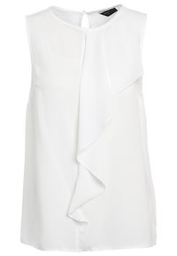 Bílá bezrukávová blůza s hladkým povrchem, která má diagonální volánový detail vpředu a otvor se zapínáním na zádech.