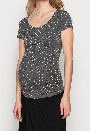 Haut gris à manches courtes avec pois blancs, doté d'un col arrondi et de fronces sur les côtés pour une coupe ajustée. Tissu doux et extensible.