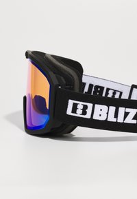 Ski goggles with a black frame, orange to blue gradient lens, soft foam padding, and a white logo on the adjustable black strap.