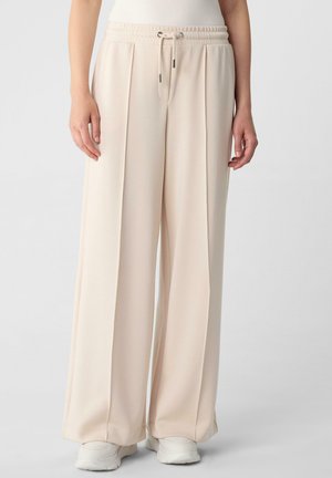 Hellebeige weit geschnittene Hosen mit einem elastischen Taillenbund und Kordelzug. Hergestellt aus glattem Stoff, mit vorderen Falten und umgeschlagenen Säumen.
