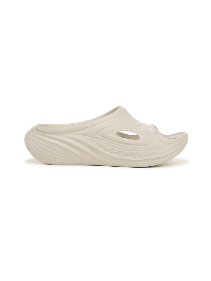 Light beige slip-on clog with a textured wavy surface, oval ventilation hole, and a curved, contoured shape for comfort.