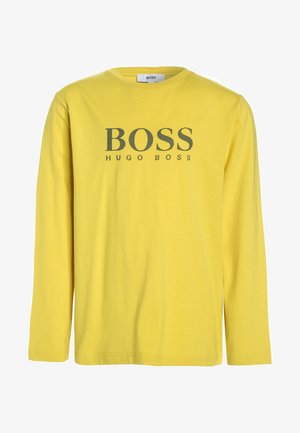 Żółta koszulka z długim rękawem wykonana z bawełny, z okrągłym dekoltem i nadrukowanym na przodzie logo "BOSS HUGO BOSS" w ciemnoszarym kolorze.