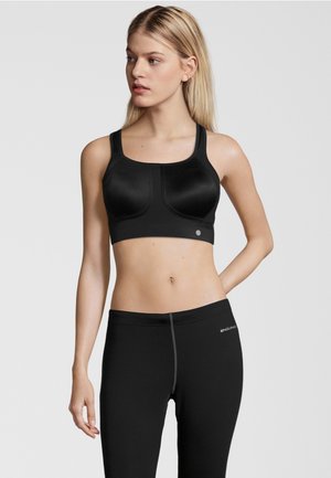 Schwarzer Sport-BH mit breiten Trägern und geformtem Design. Glattes Gewebe mit einer enganliegenden Form. Akzentuiert mit einem kleinen Logo auf der Vorderseite.