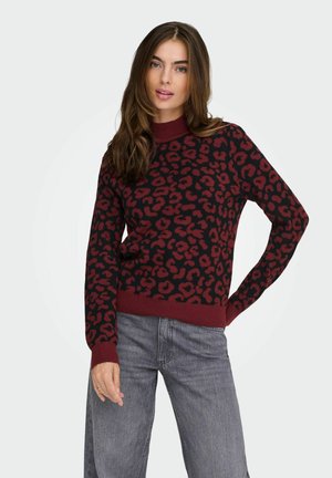 Maglione lavorato a maglia con un motivo a macchie leopardo in bordeaux e nero, con un collo alto e polsini e orlo a coste. Tessuto morbido e strutturato.