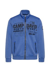 Blue zip-up jacket made of soft fabric, featuring two zippered pockets, ribbed cuffs, and printed graphics on the front.
