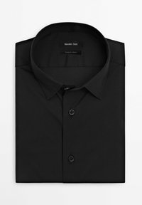 Black button-up shirt, long sleeves, classic collar, made of smooth fabric, features two black plastic buttons, neatly folded.