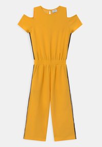 Macacão amarelo com design de ombros à mostra, mangas curtas, cintura elástica, bolsos laterais e painéis laterais pretos em contraste. Textura de tecido suave.