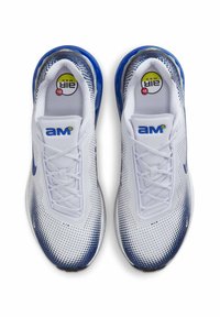 White sneakers with a mesh upper, blue accents, and a gradient dot pattern. Features a round lace-up design and a visible air cushioning unit.
