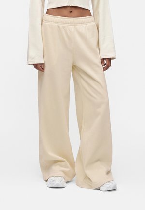 New Balance, BRUSHED COASTAL PANT - Pantaloni sportivi - beige