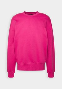 Rosa sweatshirt med rund halsringning, långa ärmar och ribbade manschetter. Tillverkad av mjukt tyg, den har en avslappnad passform och inga synliga mönster.
