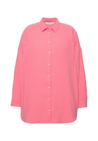 Pink, oversized button-up shirt made of textured fabric. Features a collar, long sleeves, and a row of white buttons down the front.