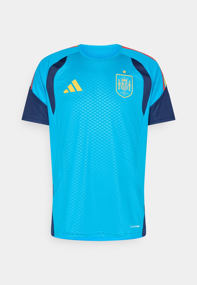Τυρκουάζ και ναυτικό αθλητικό μπλουζάκι με κοντό μανίκι, στρογγυλή λαιμόκοψη και κίτρινες λεπτομέρειες. Φέρει το σήμα της Ισπανίας και το λογότυπο της Adidas.