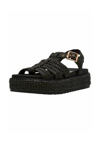 Schwarze gewebte Plattform-Sandalen mit geflochtenem Obermaterial und Schnallen-Detail, ausgestattet mit einer dicken strukturierten Sohle für Grip und Unterstützung.