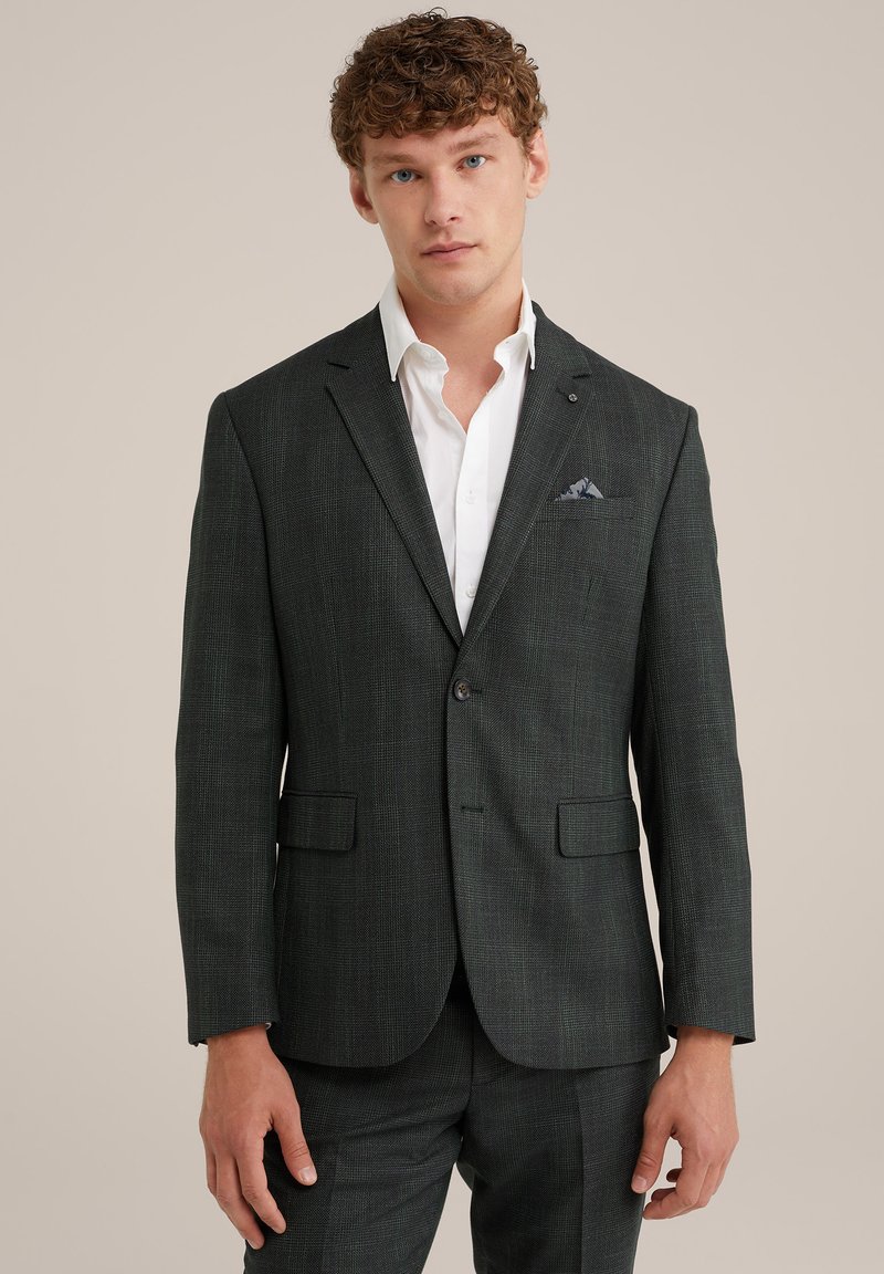 Tumši zaļš rūtainais uzvalka žakets ar izgrieztiem atlokiem, vienu pogu, divām priekšējām kabatām un kontrastējošu kabatlakatu.