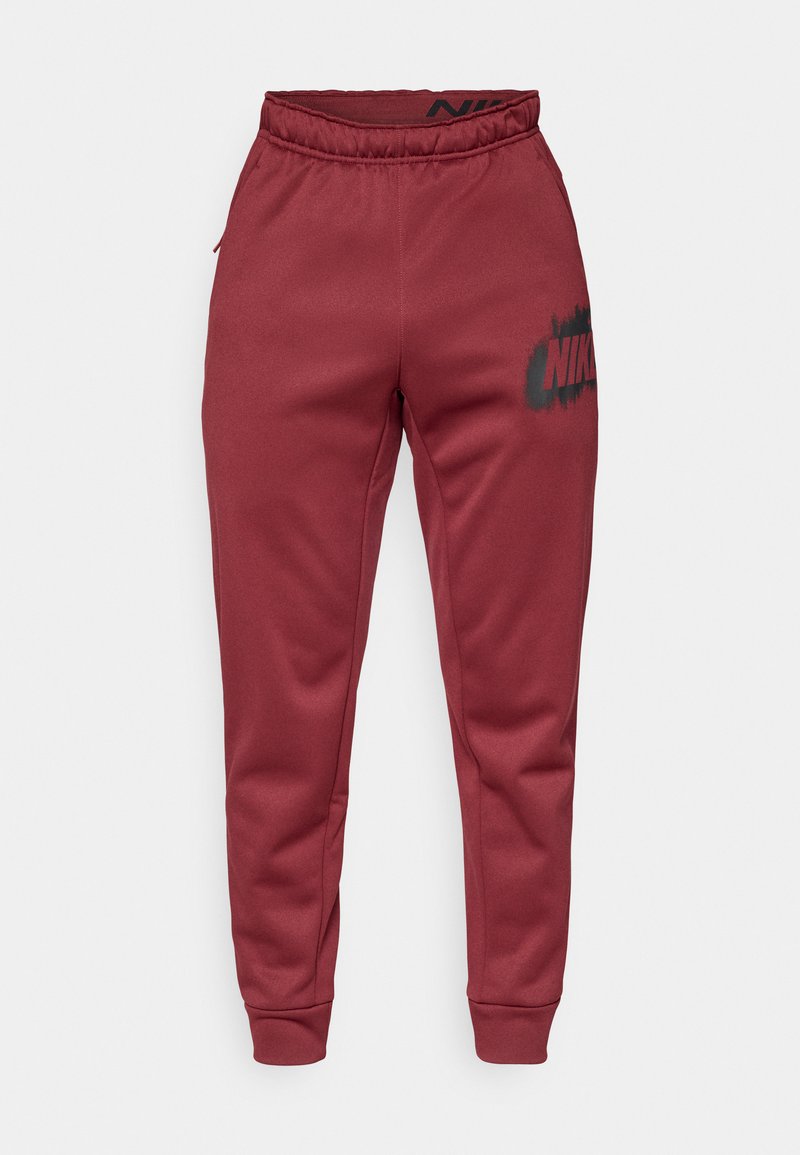 Pantaloni tuta Nike bordeaux con vita elasticizzata, gambe affusolate, tasche laterali e un logo nero sulla coscia sinistra. Tessuto morbido al tatto.