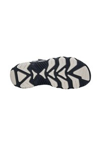 Suola di scarpa in gomma nera con una superficie texture caratterizzata da motivi geometrici bianchi e scanalature per una migliore aderenza.
