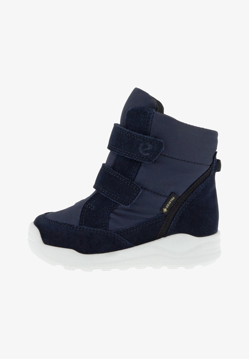 Botte d'hiver bleu marine pour enfants avec double fermeture Velcro, étiquette Gore-Tex et semelle épaisse en caoutchouc blanc, conçue pour temps froid et humide.