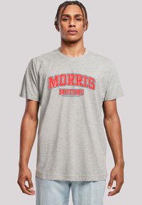 Gray cotton t-shirt with a round neckline, featuring bold red text that reads "MORRIS MOTORS." Short sleeves with a relaxed fit.