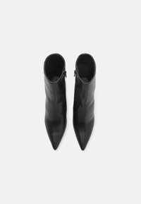 Black leather ankle boots with a pointed toe design and a smooth texture. Features a side zipper and a gold accent on the heel.