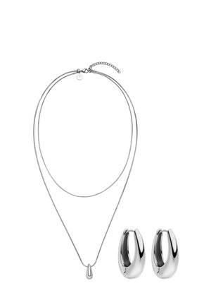 Silver double-layer necklace with teardrop pendant and matching pair of smooth, polished silver hoop earrings on white background.