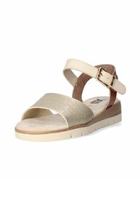 Sandalia beige con parte superior perforada, correas de cuero, hebilla ajustable y suela plana de corcho y goma con acabado texturizado.
